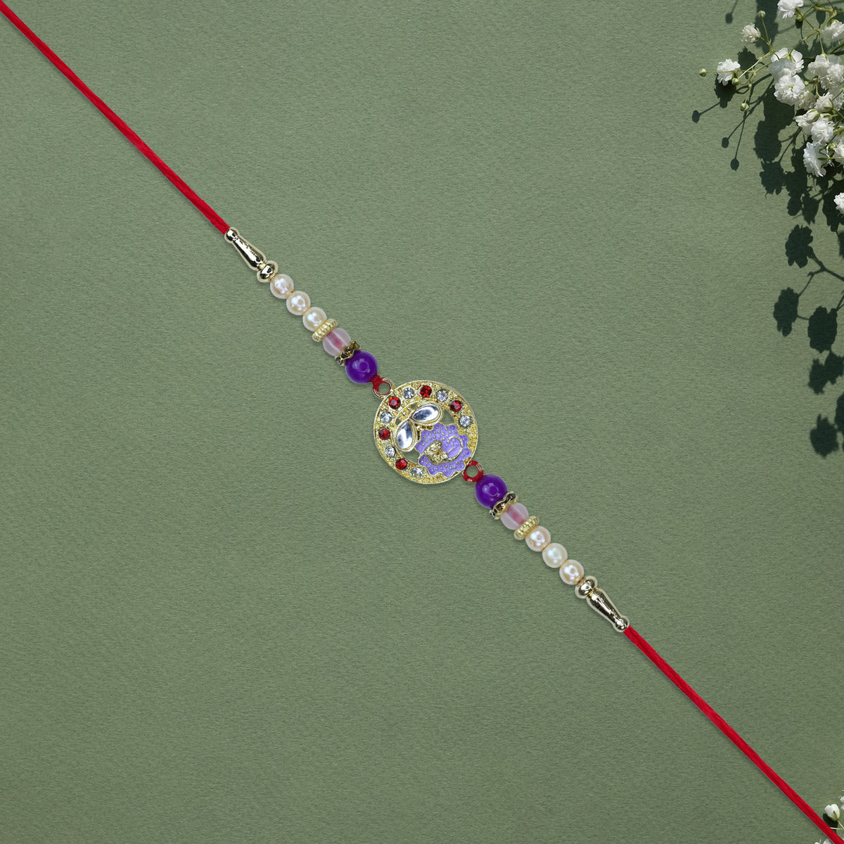 Elegant Ganesh Rakhi With Pearl And Purple Beads